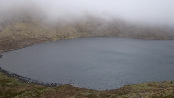 在爱尔兰的一个狂风暴雨的日子里 平静的高山湖面上点缀着低空如也的云彩 描绘着迷人的景色 — 图库视频影像