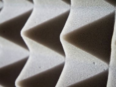 Acoustic Foam Detail. Grey foam panels with pyramid design for sound control. clipart