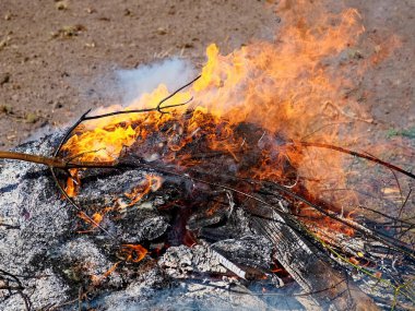 Yangının temelini saran görünür küller devam eden yanmayı gösteriyor..