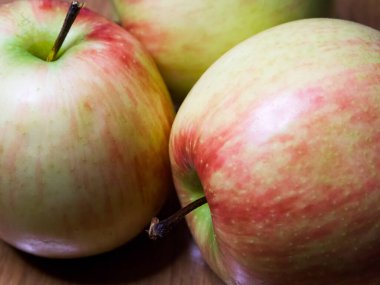 Tahtadaki organik elmalar. Ahşap zeminde bir grup elma, organik gıda pazarlaması için mükemmel..