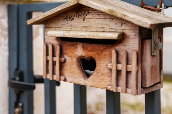 Wooden carved mailbox for love letters on Valentine day with heart shaped letterbox slot