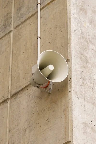 Wired loudspeaker on the wall of the stadton building close-up. Announcement of alarm and danger concept
