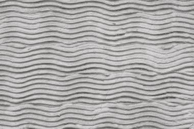 Sıvalı bir duvarda dalgalar olan soyut kıvrımlı çimento deseni. Yaratıcı arkaplan