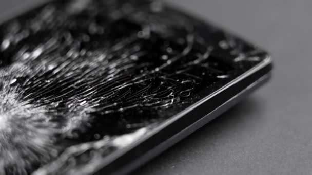 Black Smashed Crushed Mobile Phone Broken Cracked Display Macro Rotation — Stock Video