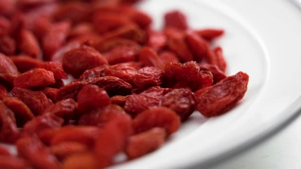 Red Dried Goji Berries White Kitchen Plate Macro Rotation — Wideo stockowe