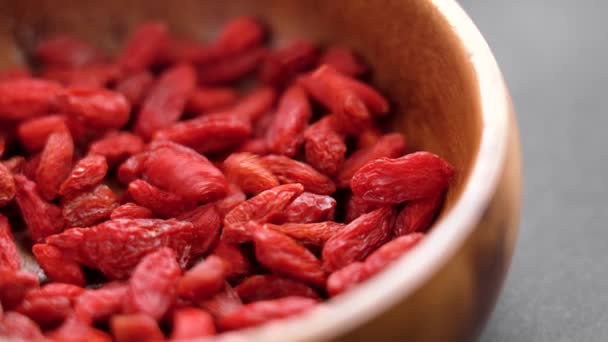 Red Organic Dried Goji Berries Falling Pile Wooden Bowl Macro — Vídeo de Stock