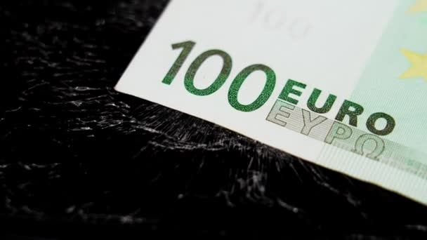 One Hundred Euro Banknote Cracked Crushed Broken Black Surface Concept — 图库视频影像