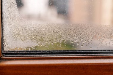 Water condensation on home window glass close up