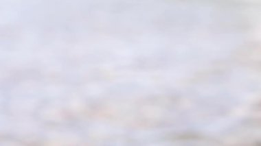 Defocused sea water surface in sunlight. Abstract light background