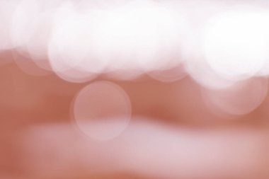 Red lens flare in blur. Defocused light. Beautiful bokeh