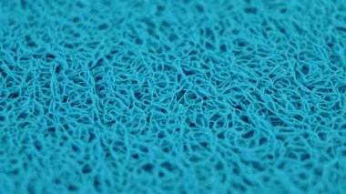 Karışık desenli mavi yumuşak kauçuk paspas. İplik lifleriyle soyut ve karmaşık yüzey. Döndürme