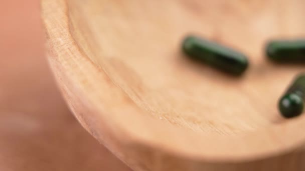 Grüne Natürliche Nahrungsergänzungskapseln Die Zeitlupe Eine Holzschale Fallen Alternative Medizin — Stockvideo