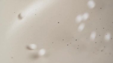 Homeopatik küreseller seramik bir kaseye dağılıyorlar. Homeopati ilacı beyaz granüller
