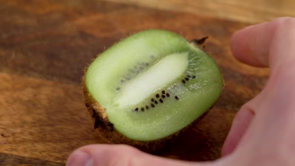 Caucasian Chef Puts Half Fresh Kiwi Fruit Cutting Board Close — Stock Video