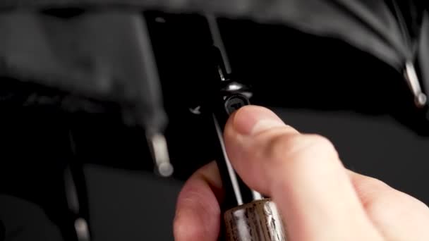Opening Classic Black Umbrella Pressing Push Button Closeup Black Background — Stock Video