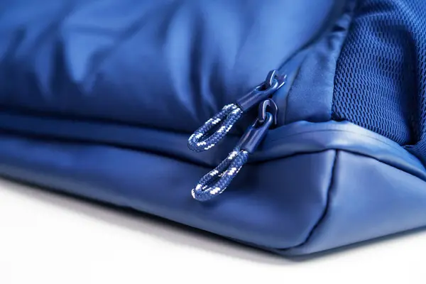 Stock image Striped zipper fasteners of a blue travel bag close up