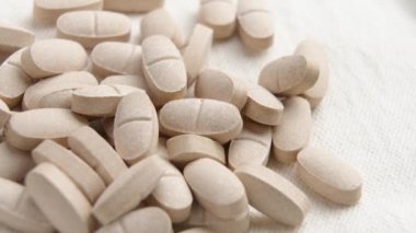 Gelişmiş zindelik ve refah için doğal takviyeler. Bej bir beze alternatif ilaç hapları. Makro atış. Döndürme