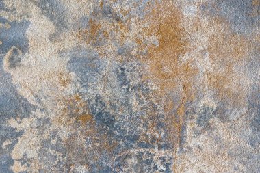 Textured stone surface with a blend of warm and cool tones, providing a rustic sophisticated look. Perfect for contemporary interior design and natural-themed decor. Abstract background.