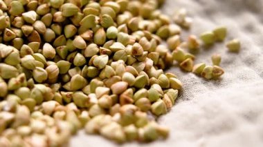 Çiğ karabuğday taneleri buruşuk bez peçeteye saçılmış. Pişmemiş aşçılık malzemeleri. Makro atış. Döndürme