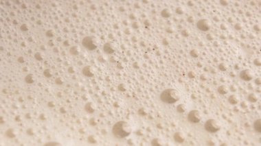 Bol köpüklü bej köpüklü muzlu süt proteini.