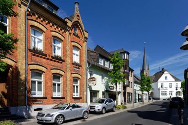 Bedburg, Germany May 11 2022: main street of the small town bedburg with the church st lambertus in the background