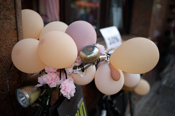 party bike with pastel balloons and artificial flowers