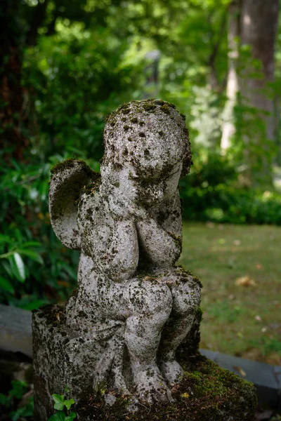 Small Tired Mossy Putto Sitting Grave Stock Picture