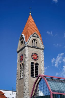 The striking tower with red roof tiles on the spire of the Church of the Resurrection of Christ of the Old Catholics in Cologne clipart