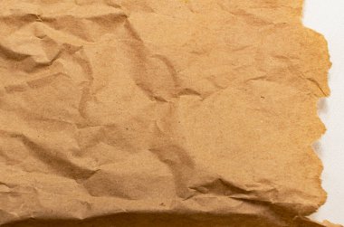 Rumpled brown cardboard paper texture background with copy space