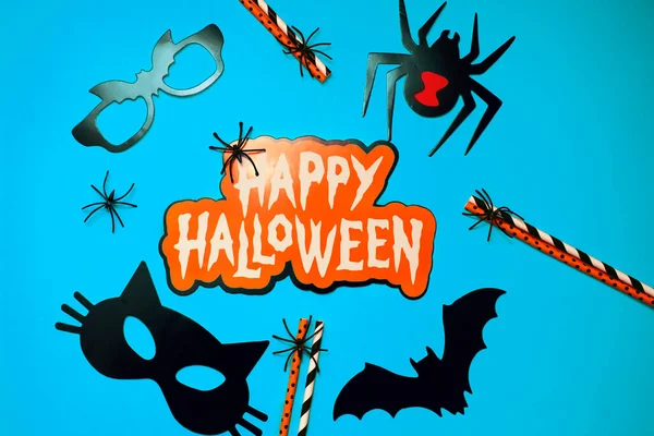 Halloween decor set, spider, bat glasses, black cat. Congratulatory banner with Halloween on a blue background