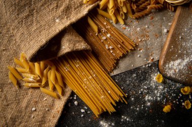 Farklı türde makarna. Makarna masanın üstünde. Çiğ makarna. Doku.