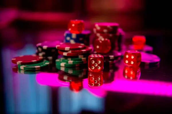 Casino. Poker. Game pieces and dice are on the table. Game chips for betting in gambling. Dice. Poker chips.