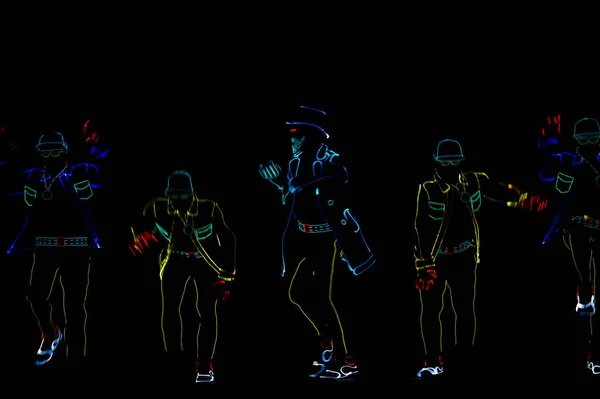 Silhouetten Van Mensen Lichtgevende Pakken Een Zwarte Achtergrond Neon Kostuum — Stockfoto
