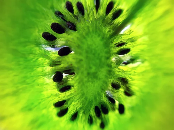 Bright green kiwi fruit in a cut macro.Close-up of a kiwi in a cut.