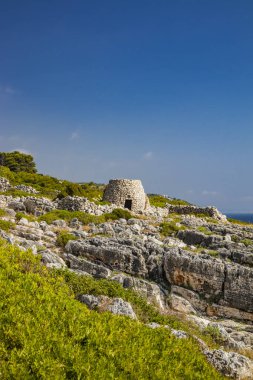 Gagliano del Capo. The beautiful panorama on the blue sea, from the rocky cliff of Salento. An old stone trullo. The nature trail that leads from the Ciolo bridge to the spectacular Cipolliane caves.