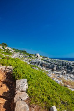 Gagliano del Capo. The beautiful panorama on the blue sea, from the rocky cliff of Salento. An old stone trullo. The nature trail that leads from the Ciolo bridge to the spectacular Cipolliane caves.