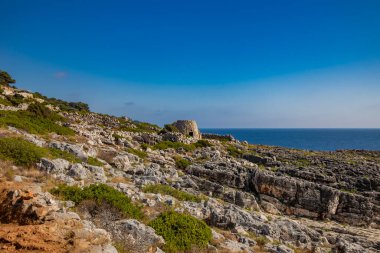 Gagliano del Capo. The beautiful panorama on the blue sea, from the rocky cliff of Salento. An old stone trullo. The nature trail that leads from the Ciolo bridge to the spectacular Cipolliane caves.