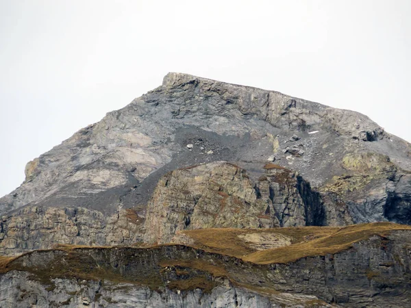 stock image Rocky alpine peak Piz Fluaz (2814 m) over the Panixersee lake and in the Glarus Alps mountain massif, Pigniu-Panix - Canton of Grisons, Switzerland (Kanton Graubuenden, Schweiz)