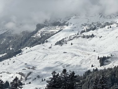 A wonderfully beautiful winter setting with a fresh snow cover in the Swiss Alps and above the Lake Walen or Lake Walenstadt (Walensee), Amden - Canton of St. Gallen, Switzerland / Schweiz