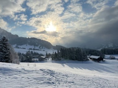 Icy winter sun over a fresh snow cover in the Swiss Alps and in the Amden winter resort area above the Lake Walen or Lake Walenstadt (Walensee) - Canton of St. Gallen, Switzerland / Schweiz