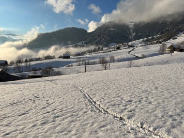 Wonderful winter hiking trails and traces over the Lake Walen or Lake Walenstadt (Walensee) and in the fresh alpine snow cover of the Swiss Alps, Amden - Canton of St. Gallen, Switzerland / Schweiz
