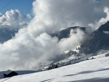 Beautiful low winter clouds and fog condensation in the Swiss Alps during a polar cold snap, Amden - Canton of St. Gallen, Switzerland / Schweiz