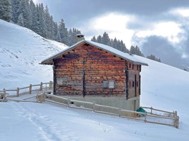 Old traditional swiss rural architecture and alpine livestock farms in the winter ambience of the tourist resorts of Valbella and Lenzerheide in the Swiss Alps - Canton of Grisons, Switzerland / Schweiz