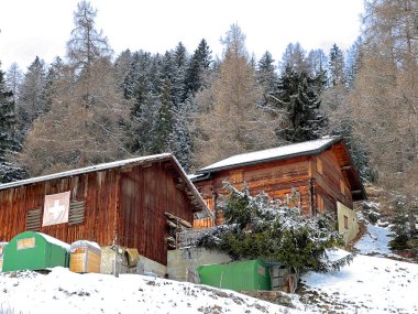 Old traditional swiss rural architecture and alpine livestock farms in the winter ambience of the tourist resorts of Valbella and Lenzerheide in the Swiss Alps - Canton of Grisons, Switzerland / Schweiz