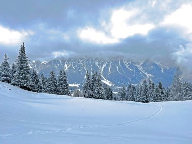 Beautiful low winter clouds and fog condensation in the Swiss Alps above the tourist resorts of Valbella and Lenzerheide in the Swiss Alps - Canton of Grisons, Switzerland (Schweiz)