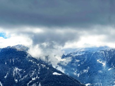 Beautiful low winter clouds and fog condensation in the Swiss Alps above the tourist resorts of Valbella and Lenzerheide in the Swiss Alps - Canton of Grisons, Switzerland (Schweiz)