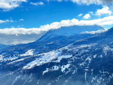 Beautiful low winter clouds and fog condensation in the Swiss Alps above the tourist resorts of Valbella and Lenzerheide in the Swiss Alps - Canton of Grisons, Switzerland (Schweiz)