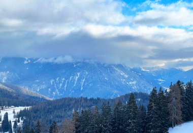 Beautiful low winter clouds and fog condensation in the Swiss Alps above the tourist resorts of Valbella and Lenzerheide in the Swiss Alps - Canton of Grisons, Switzerland (Schweiz)