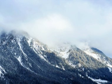 Beautiful low winter clouds and fog condensation in the Swiss Alps above the tourist resorts of Valbella and Lenzerheide in the Swiss Alps - Canton of Grisons, Switzerland (Schweiz)