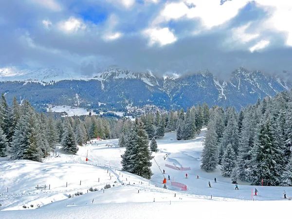 Snowboard and ski trails or alpine trails for winter sports above the tourist resorts of Valbella and Lenzerheide in the Swiss Alps - Canton of Grisons, Switzerland / Schweiz